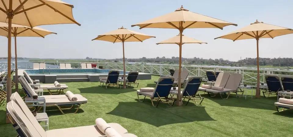 Jaz Regent Nile Cruise sun deck with swimming pool, loungers, parasols, and panoramic Nile views