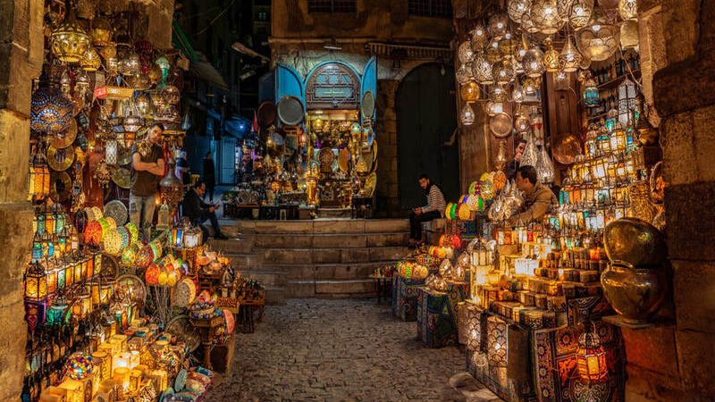 A colorful alleyway in Khan El Khalili bazaar filled with shops, souvenirs, and traditional lanterns