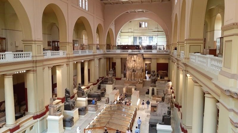 Visitors exploring ancient artifacts inside the Egyptian Museum during a Cairo day tour