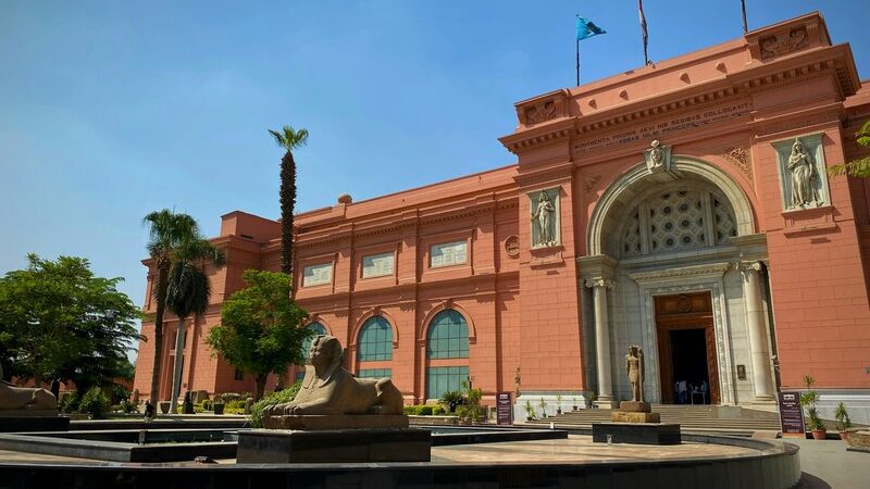 Visitors on a tour to the Egyptian Museum in Cairo, viewing ancient Egyptian artifacts and treasures