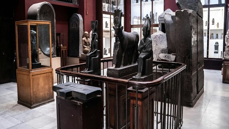 Interior of the Egyptian Museum in Cairo displaying ancient Egyptian statues, artifacts, and historical treasures.