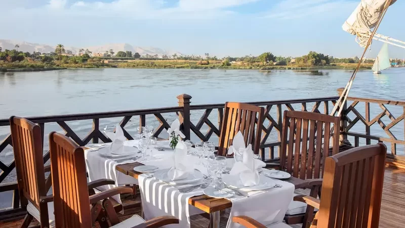 Outdoor dining on Farouz El Nil I Dahabiya with Nile River views