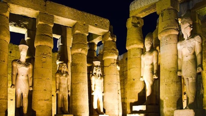 Luxor Temple illuminated at night with LED lighting, showcasing its ancient columns and dramatic facade.