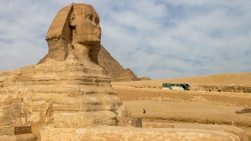 The Great Sphinx of Giza with the pyramids in the background, a highlight of any tour to Giza Pyramid.
