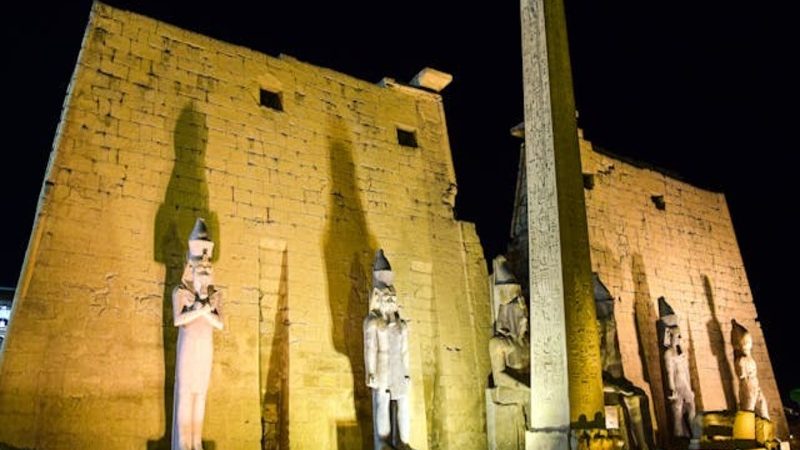Side view of Luxor Temple’s massive stone columns and ancient inscriptions, a key landmark in Upper Egypt.